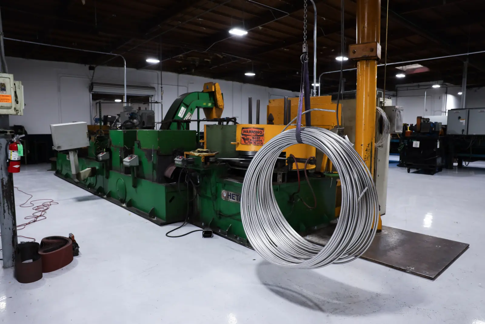 A coil of drawn wire hanging beside the drawing equipment at Brown Pacific