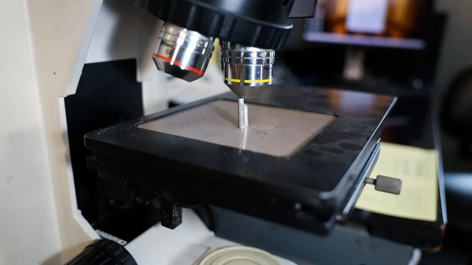 A microscope on the lab bench, set up to inspect a wire sample